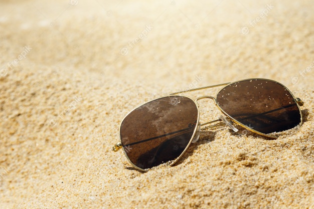 sunglasses-on-the-sand_144962-6254.jpg